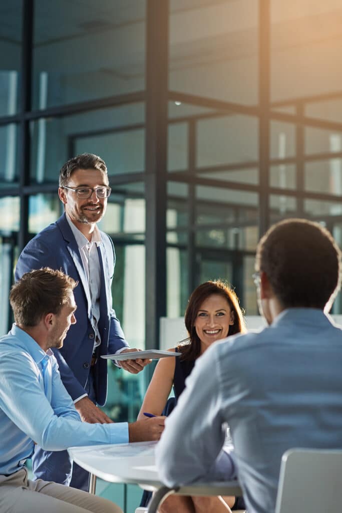 Leader, feedback or business people with tablet for planning, investment research or budget advice. Teamwork, manager and financial advisor in discussion for accounting review, meeting and report